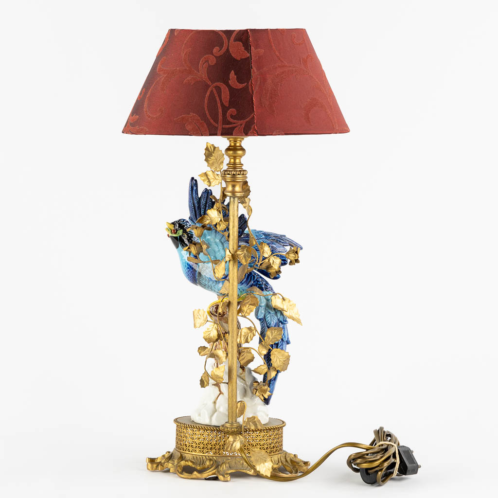 A decorative table lamp, brass mounted with polychrome porcelain. (L:16 x W:18 x H:45 cm)