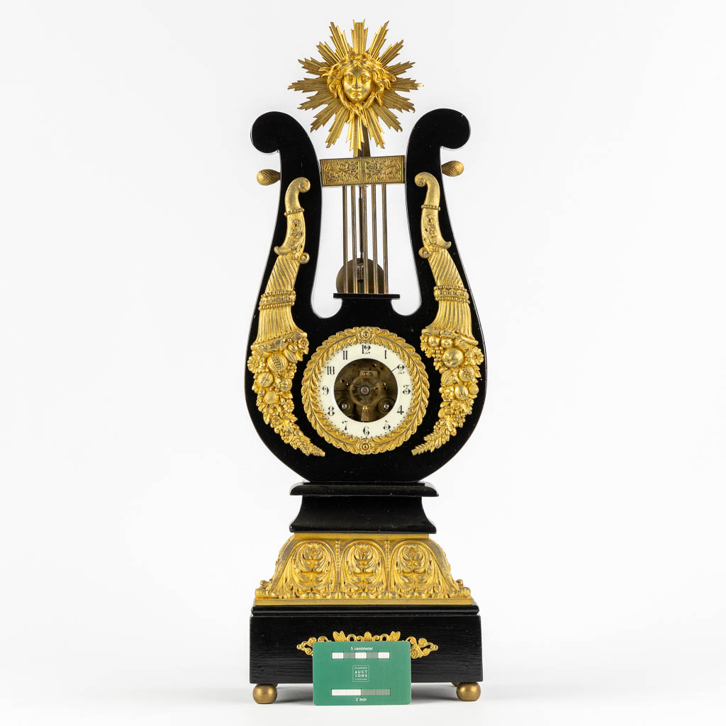 A Lyre mantle clock, gilt bronze and marble. 19th C. (L:13 x W:22 x H:61 cm)