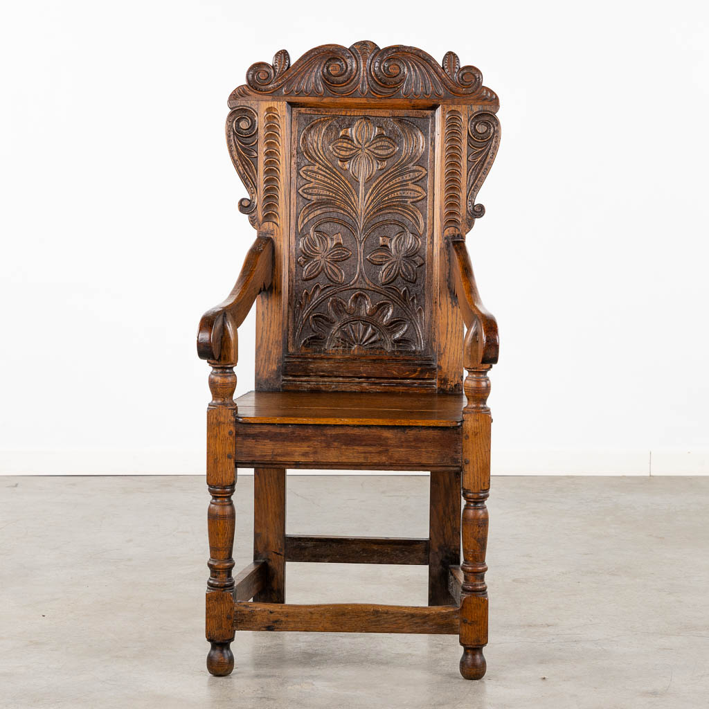 A wood-sculptured armchair, Flanders, 18th C. (L:55 x W:55 x H:117 cm)