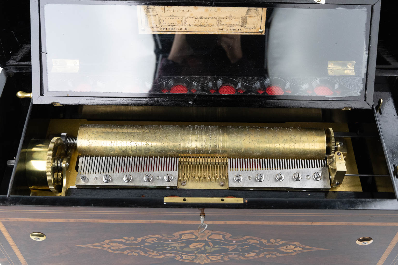 A large music box with an internal organ, in a marquetry inlay box. (L:30 x W:71 x H:27 cm)