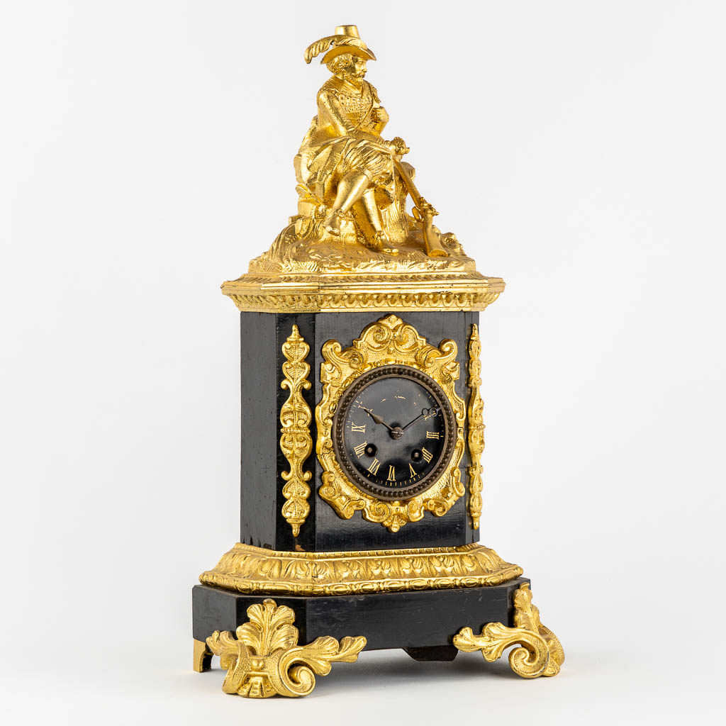 A mantle clock with a 'Hunter', gilt spelter mounted on ebonised wood. 19th C.