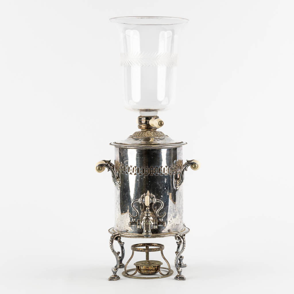 A silver-plated samovar with a glass top, standing on lion feet. (W:33 x H:51 cm)