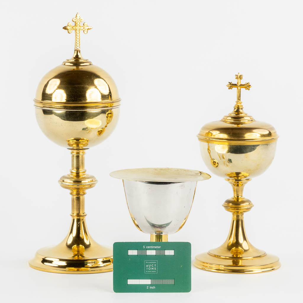 Two gold-plated Gothic Revival Ciboria and a modernist Chalice with paten. (H:30 x D:12 cm)