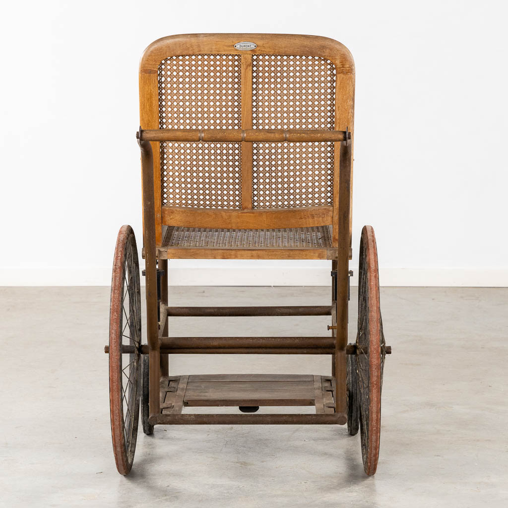 Dupont, Paris, an antique wheelchair. Circa 1900-1920. (L:97 x W:68 x H:105 cm)