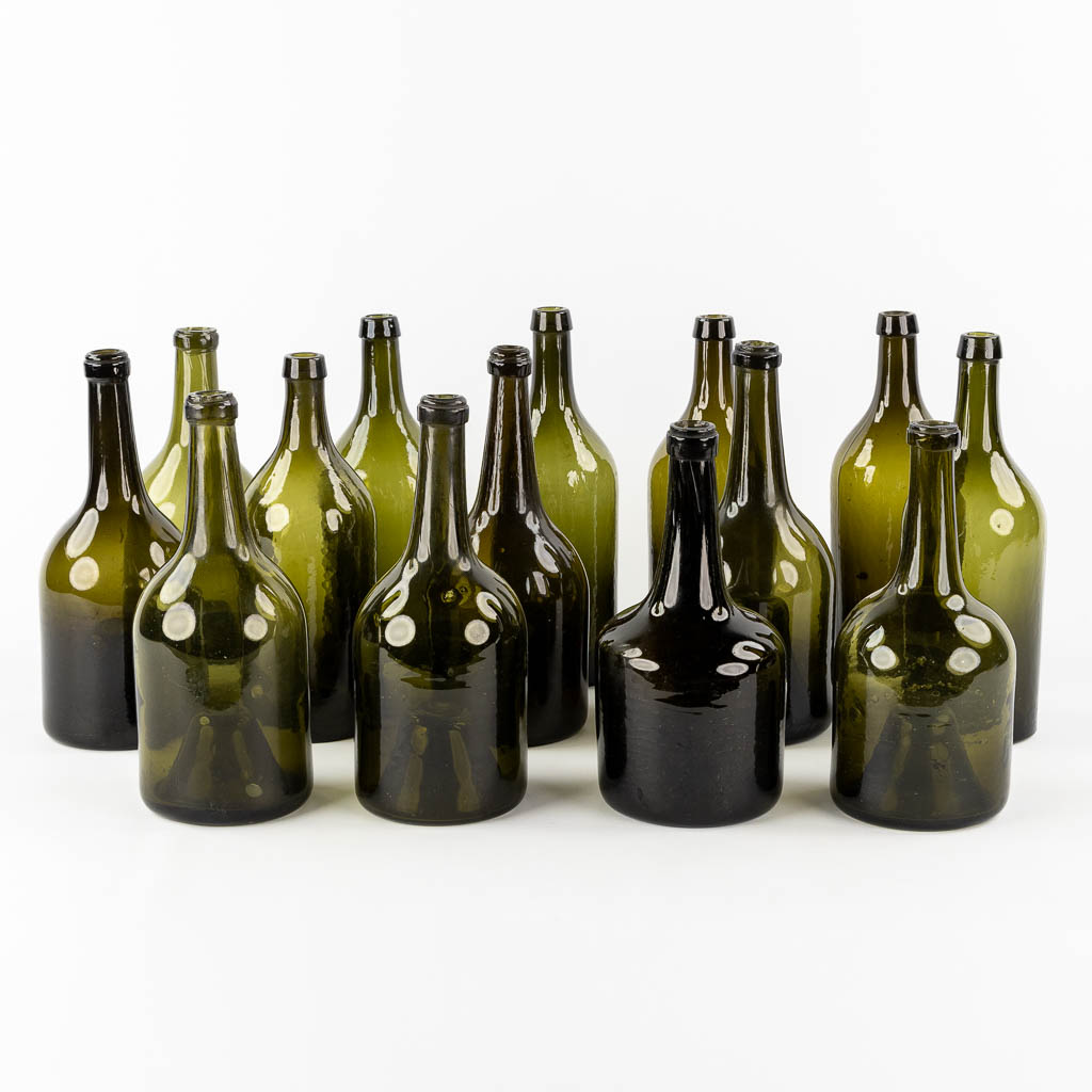 Fourteen antique glass bottles. Olive green glass. 18th and 19th C.