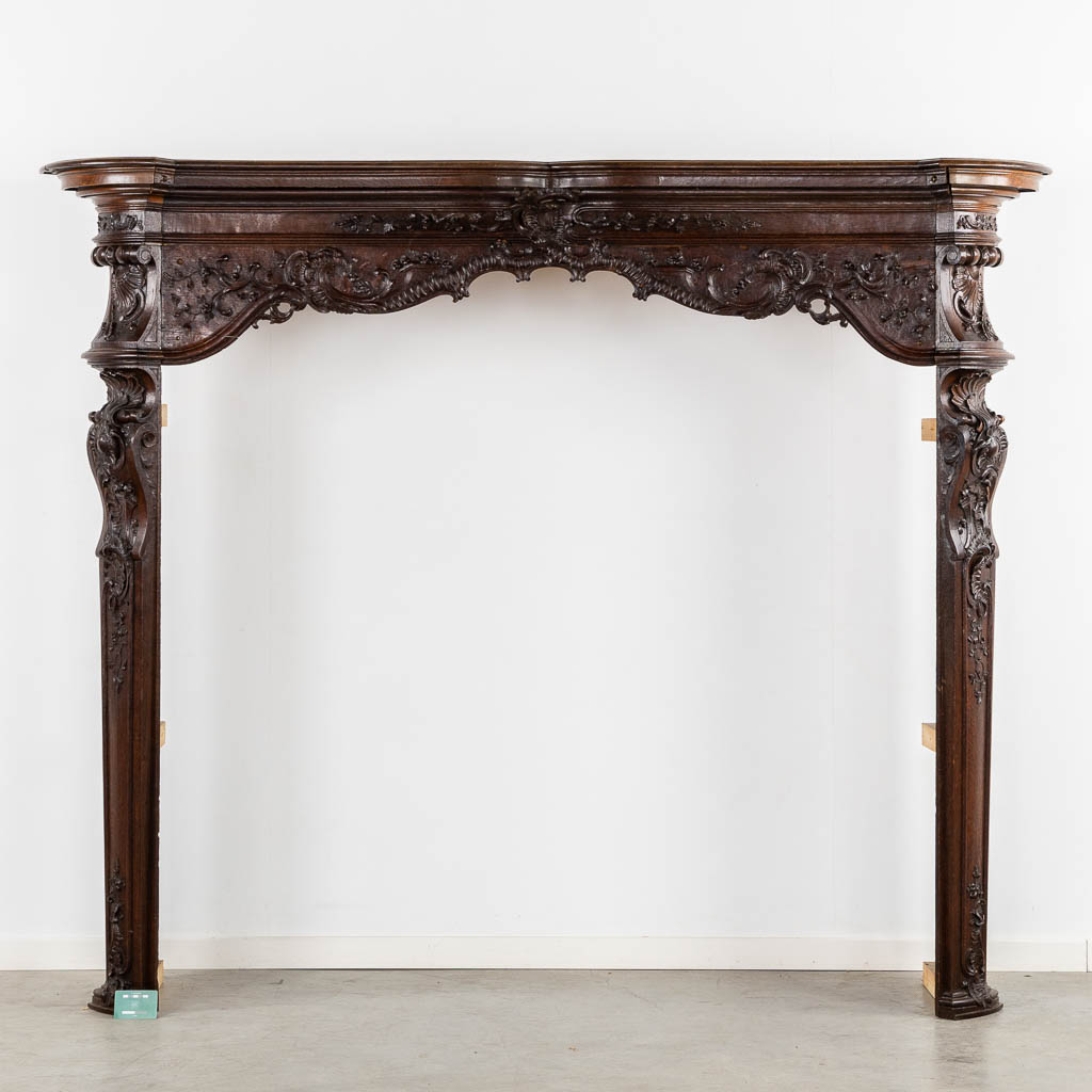 A large sculptured fireplace mantle, Liège, 18th C. (L:55 x W:209 x H:170 cm)