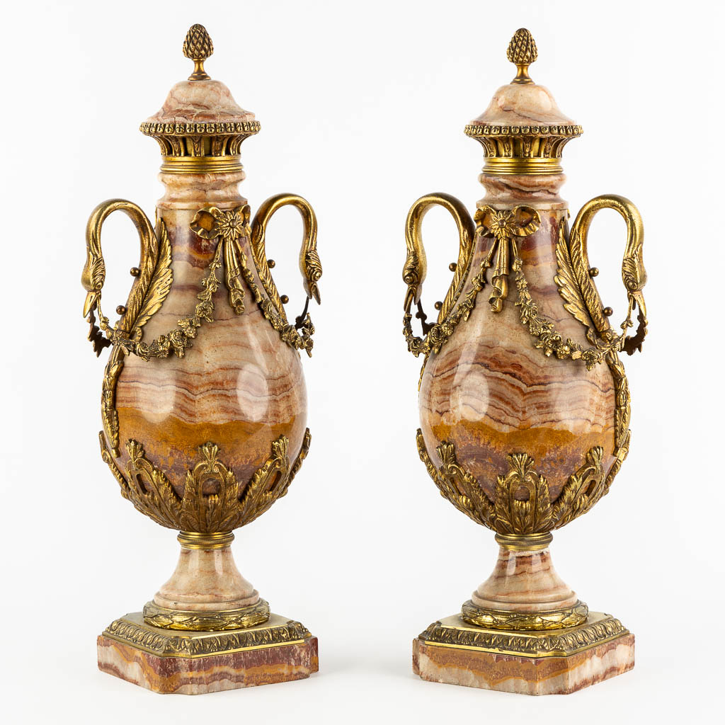 A pair of marble and bronze cassolettes in Empire style, decorated with swans. Circa 1880. (L:17 x W:21 x H:53 cm)