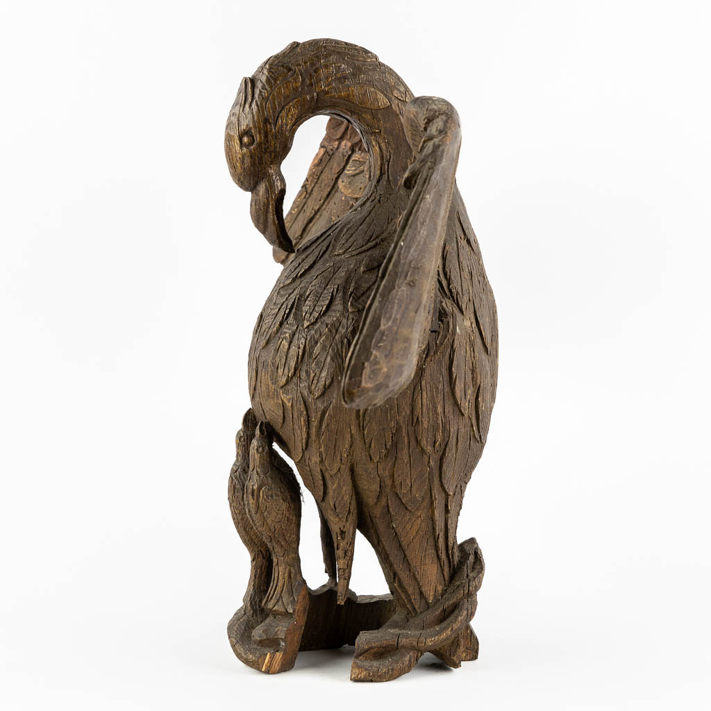 An antique wood-sculptured 'Pelican With Chicks'. 18th/19th C.