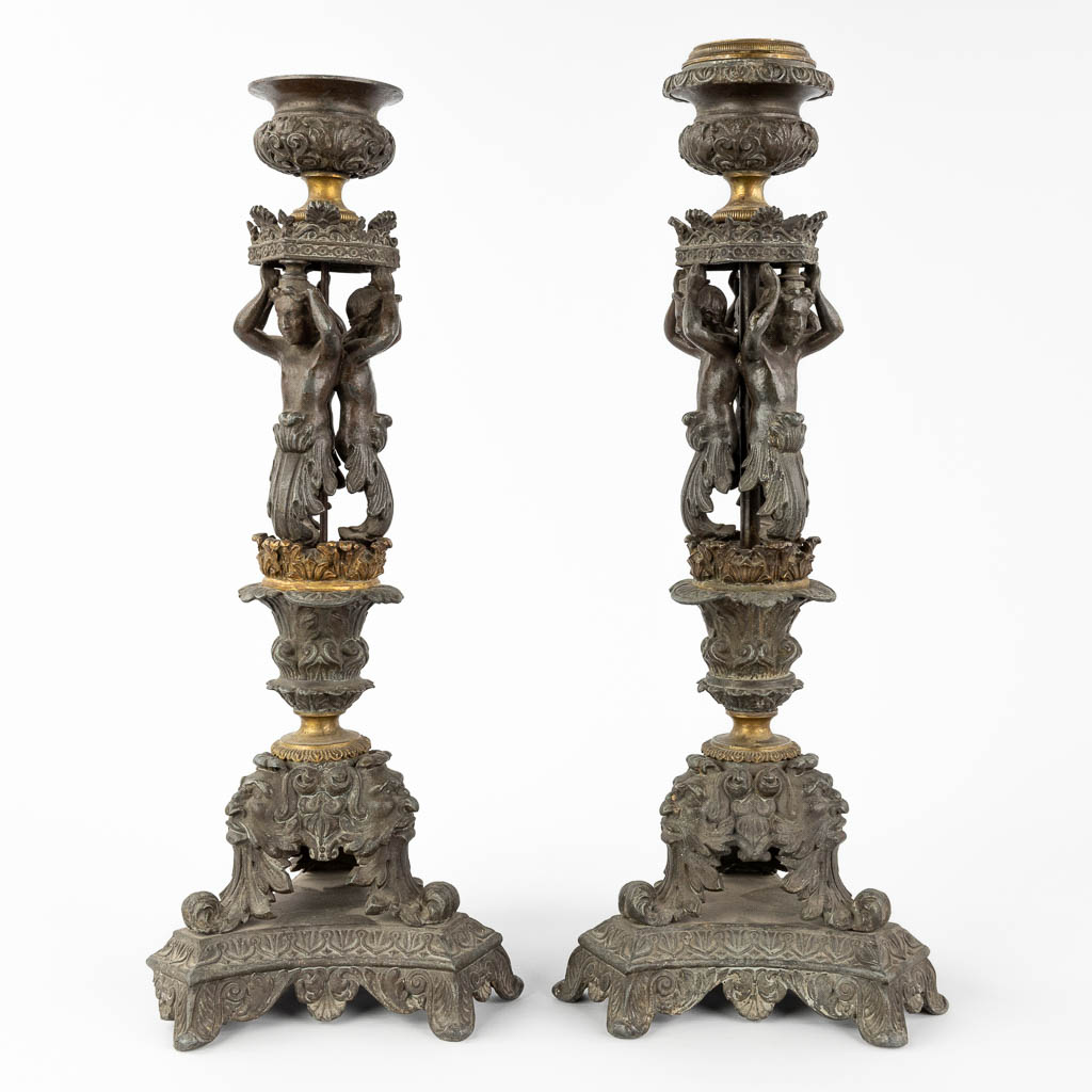 A pair of candlesticks decorated with Karyatids. Spelter and bronze. 19th C. (L:17 x W:17 x H:48 cm)