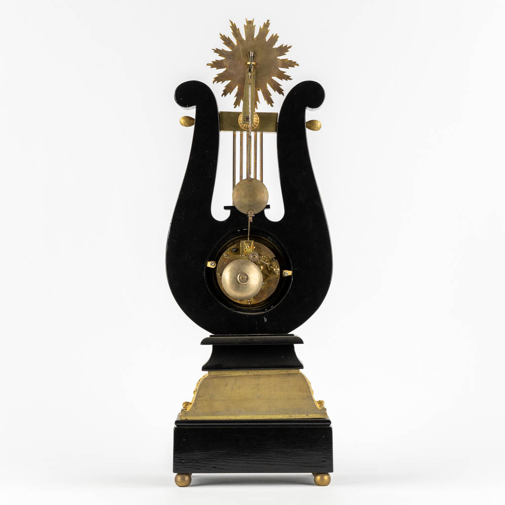 A Lyre mantle clock, gilt bronze and marble. 19th C. (L:13 x W:22 x H:61 cm)