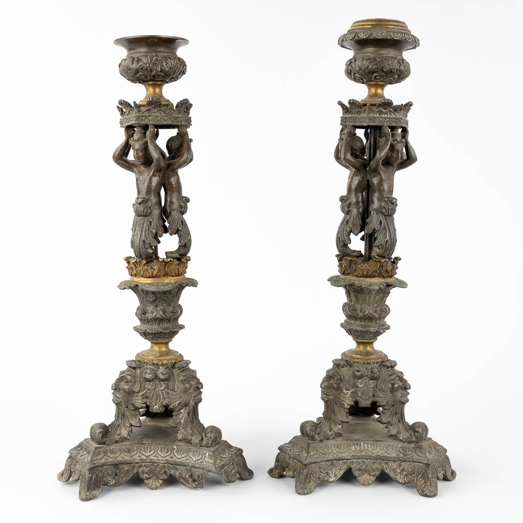 A pair of candlesticks decorated with Karyatids. Spelter and bronze. 19th C. (L:17 x W:17 x H:48 cm)