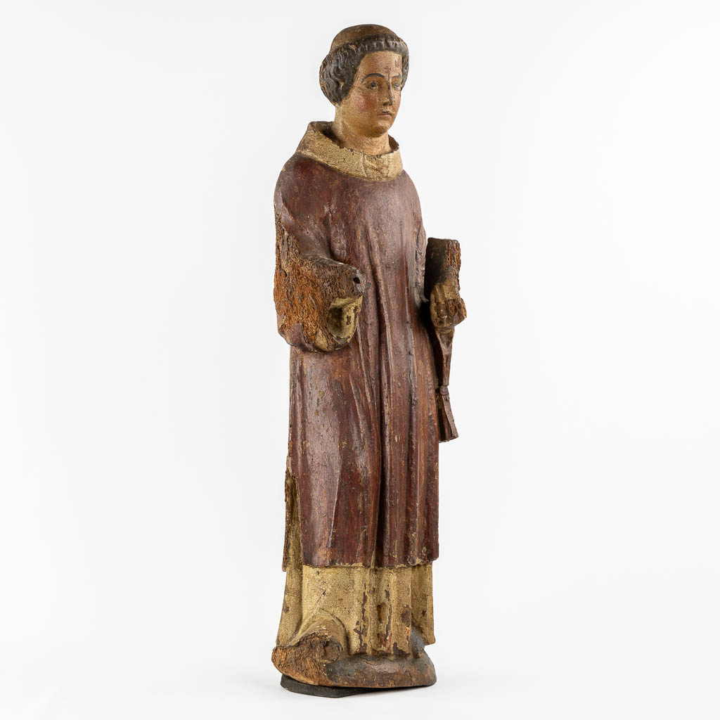 Saint Laurentius, Deacon. A wood-sculpture, oak, 14th C.  (L:20 x W:25,5 x H:90 cm)