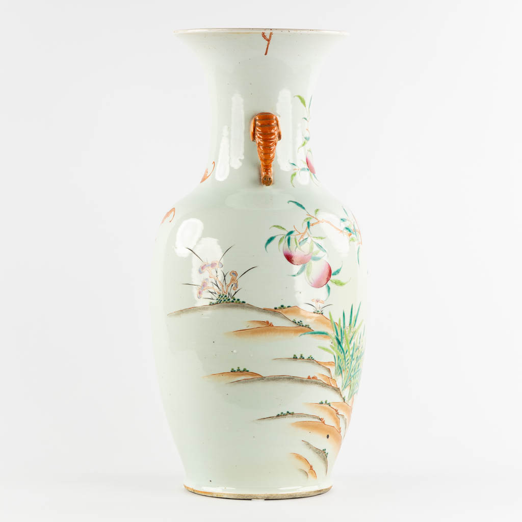 A large Chinese Famille Rose vase with a peach decor and elephant handles. 19th C. (H:70 x D:34 cm)