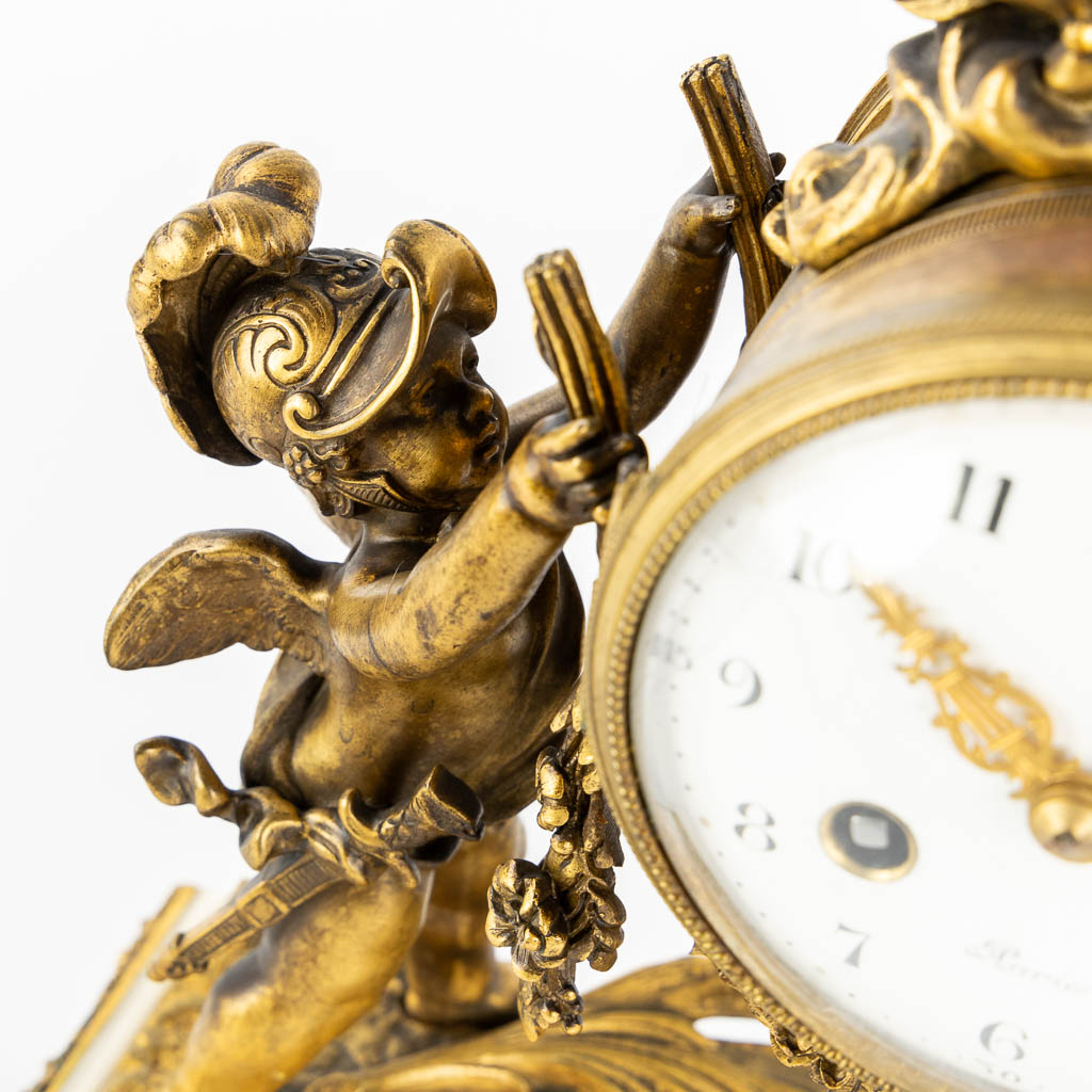 A three-piece mantle garniture clock and candelabra, bronze and marble, 19th C. (L:11 x W:27 x H:36 cm)