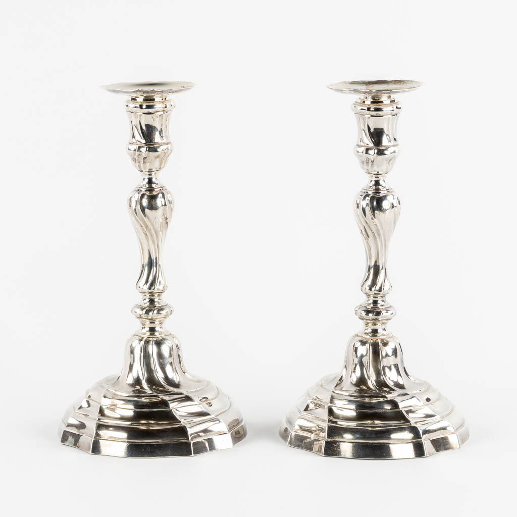 A pair of Louis XV style candlesticks, Silver, 1815-1832, after 18th C. models. 652g. 