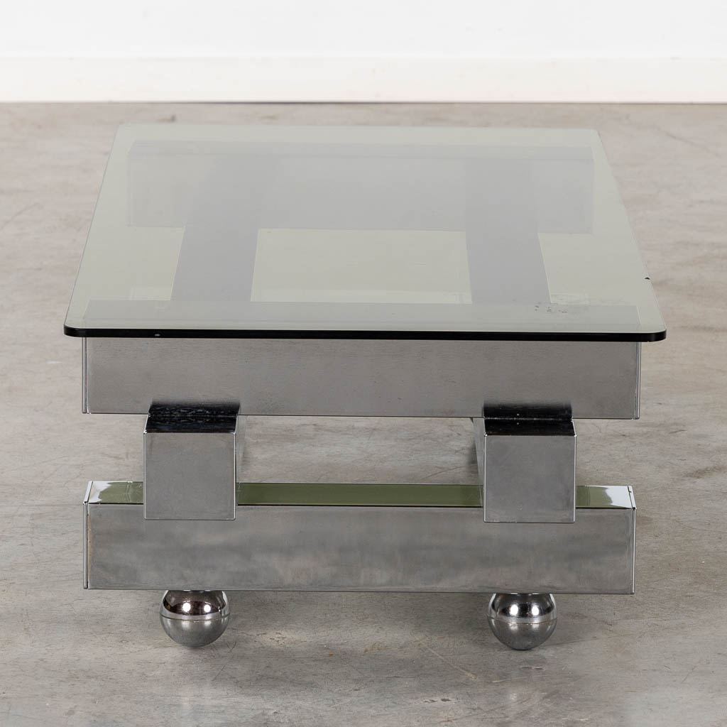 A coffee table, chromed steel and glass. (L:52 x W:104 x H:31 cm)