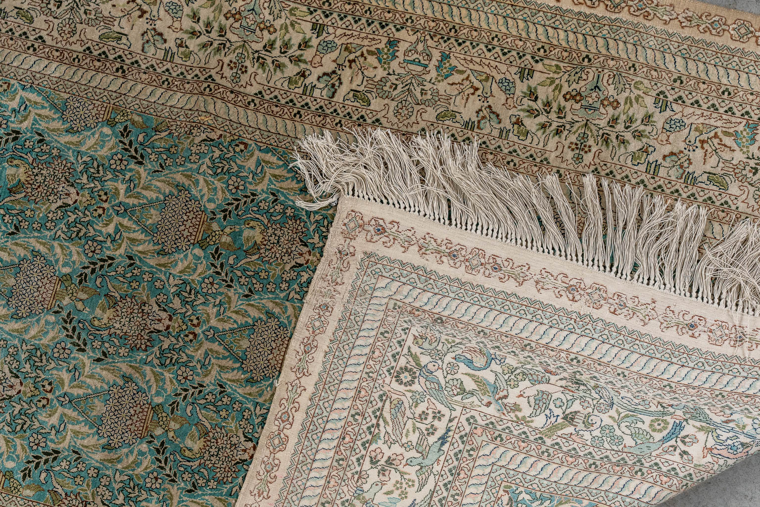 An Oriental hand-made carpet, fauna and flora decor, silk. (L:153 x W:93 cm)