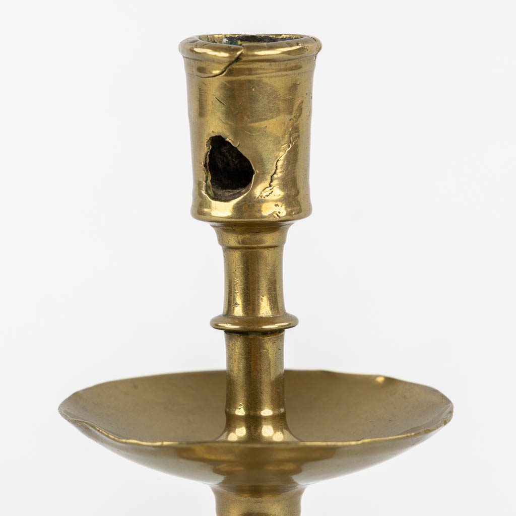 A brass disk candlestick, so-called 