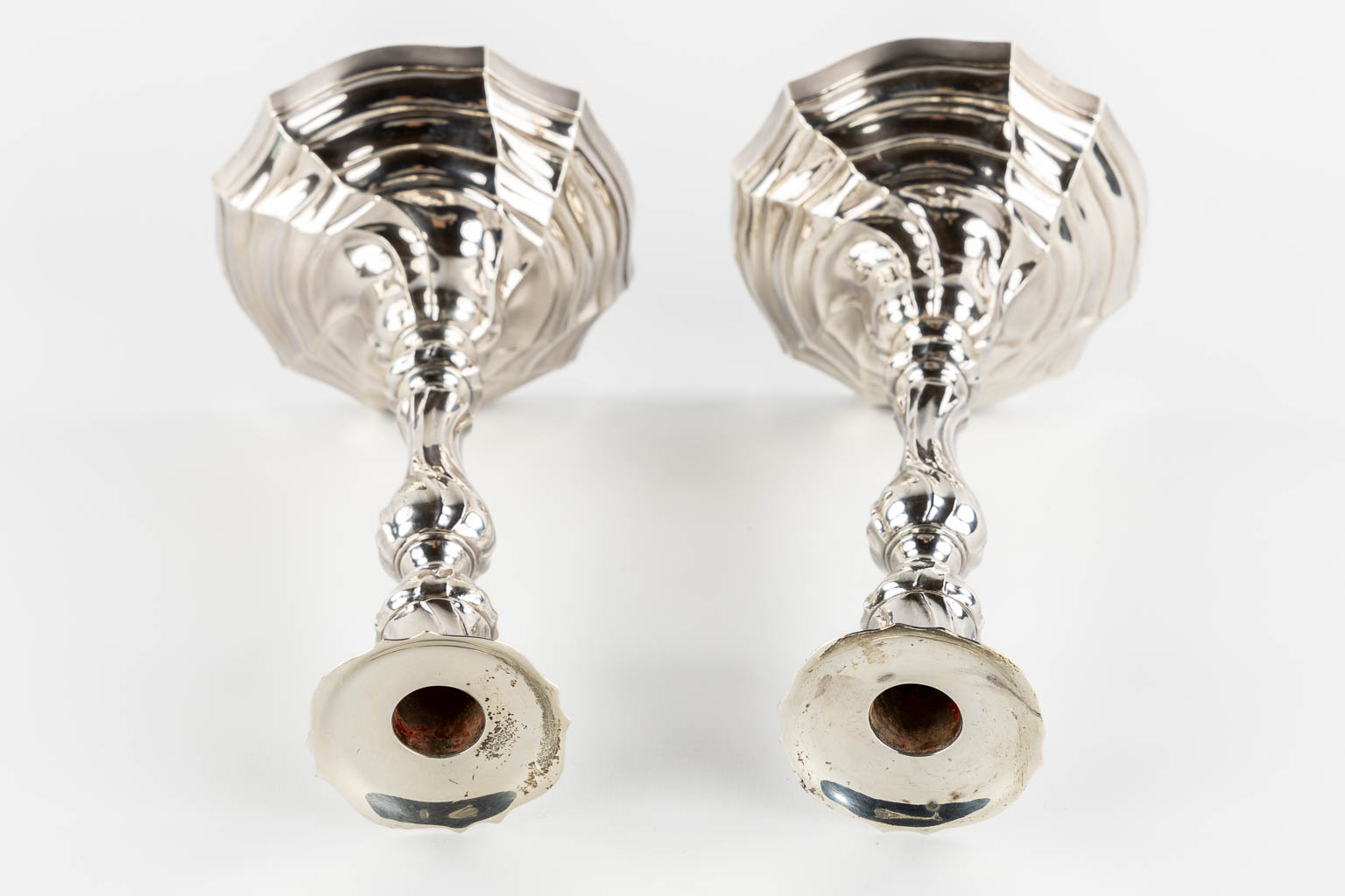 A pair of Louis XV style candlesticks, Silver, 1815-1832, after 18th C. models. 652g. 