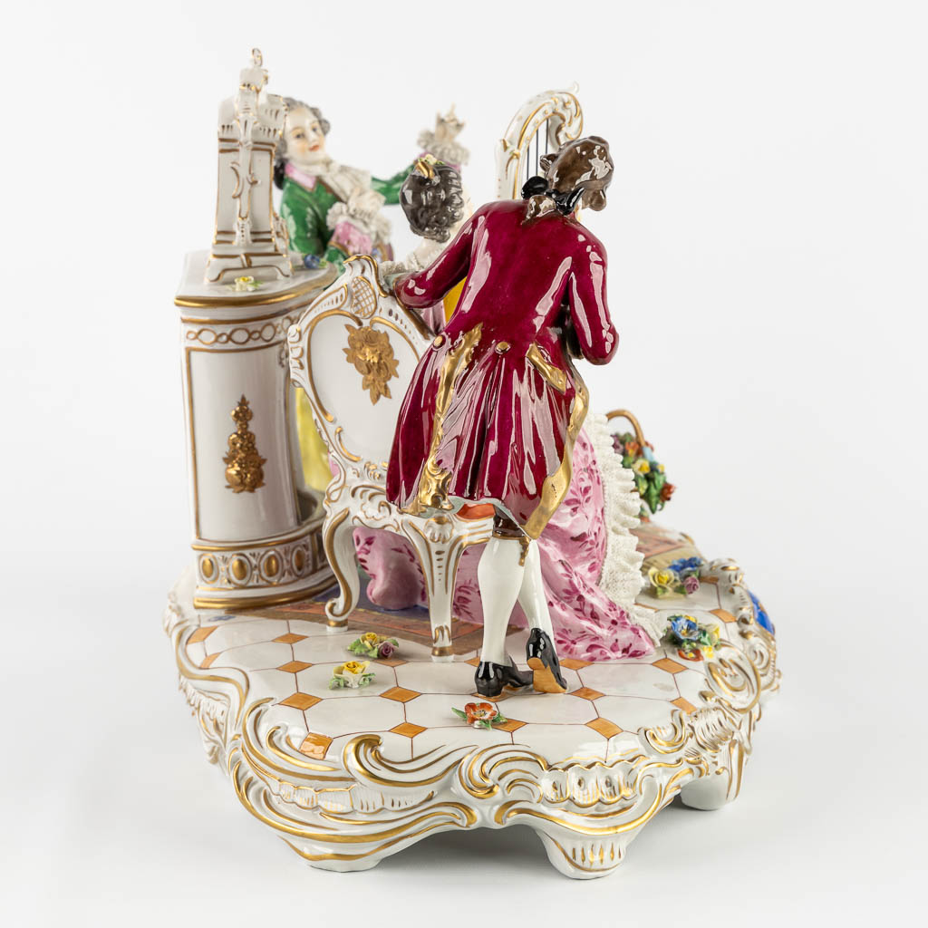 Volkstedt Rudolstadt, a large group 'Playing the harp' polychrome porcelain. 