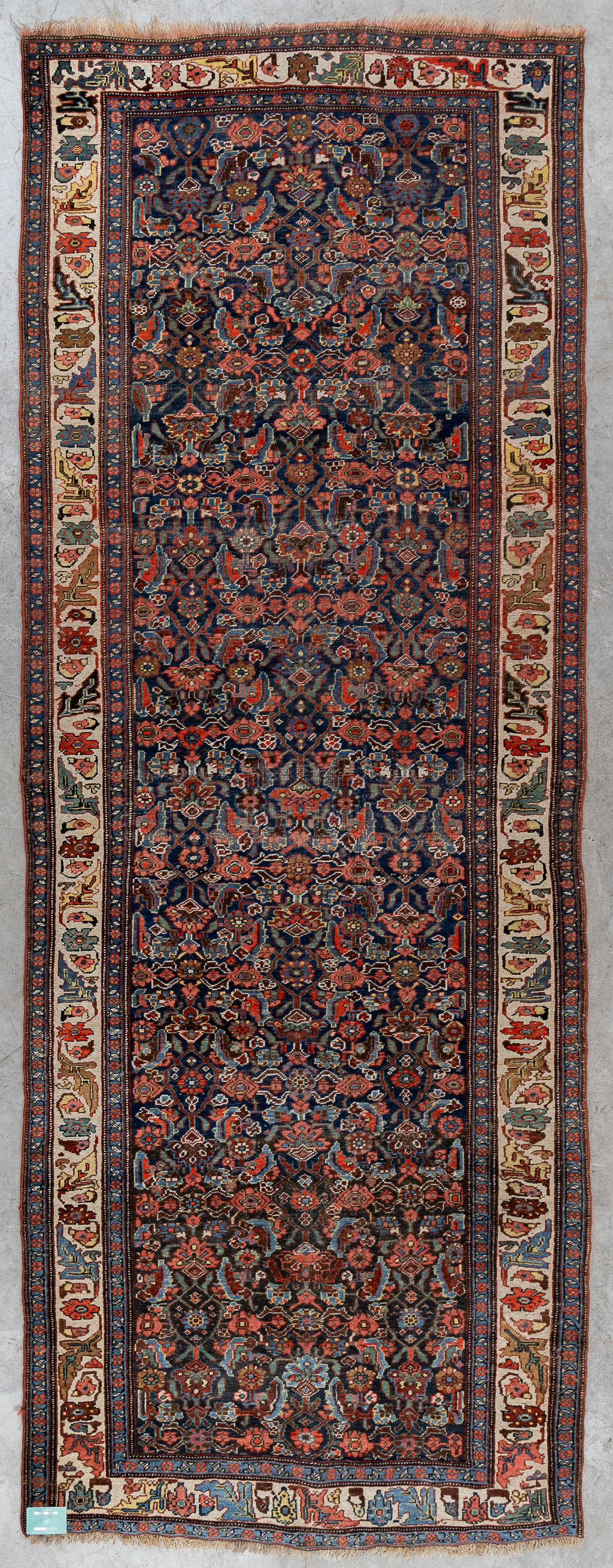 A Persian hand-made runner with floral decor. (L:120 x W:319 cm)