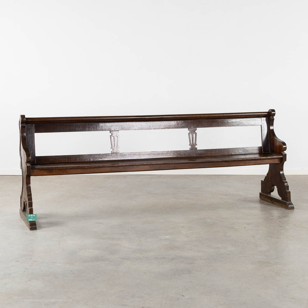 An antique Chruch bench, dark patinated oak, 18th C. (L:54 x W:239 x H:90 cm)