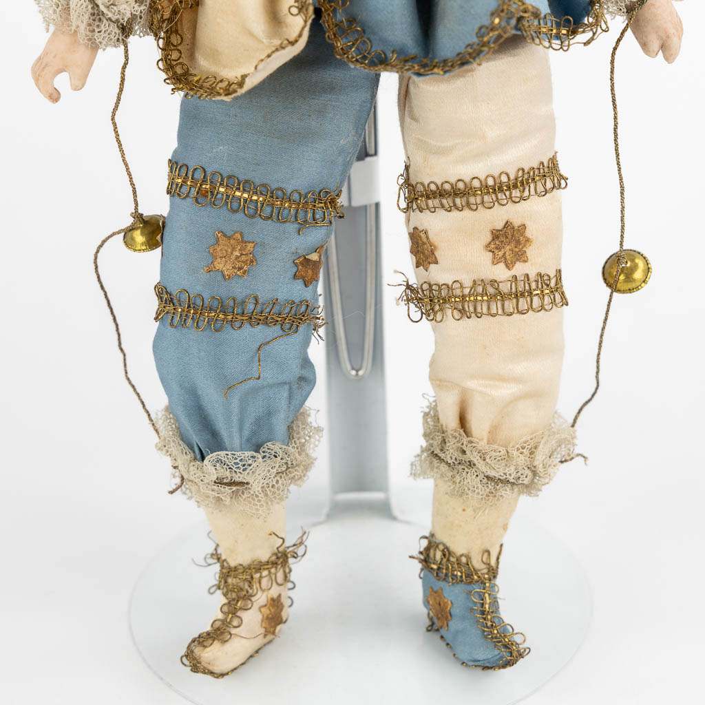 A French porcelain and fabric doll, Policinelle