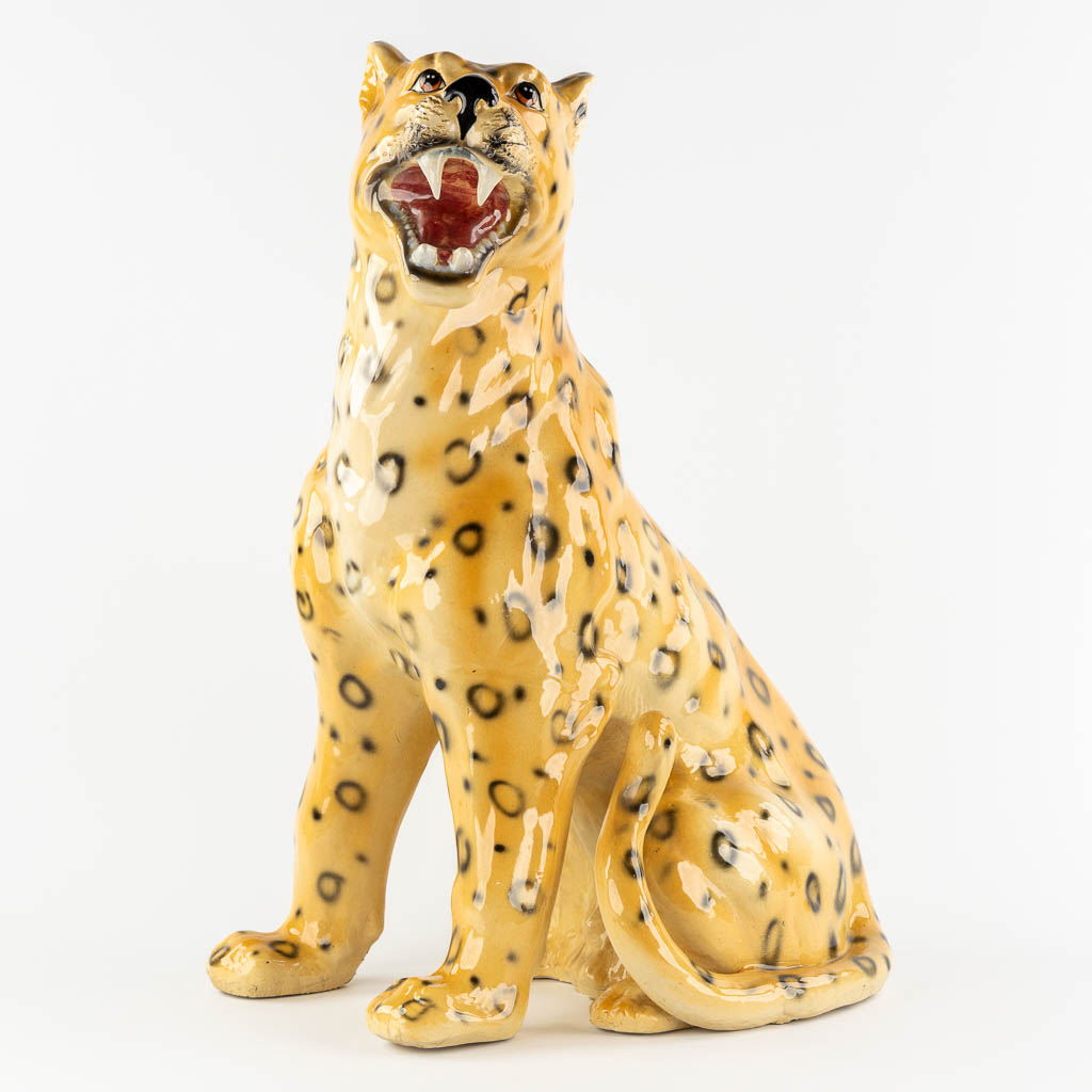 A large glazed faience Leopard, Italy, 20th C. (L:33 x W:46 x H:73 cm)