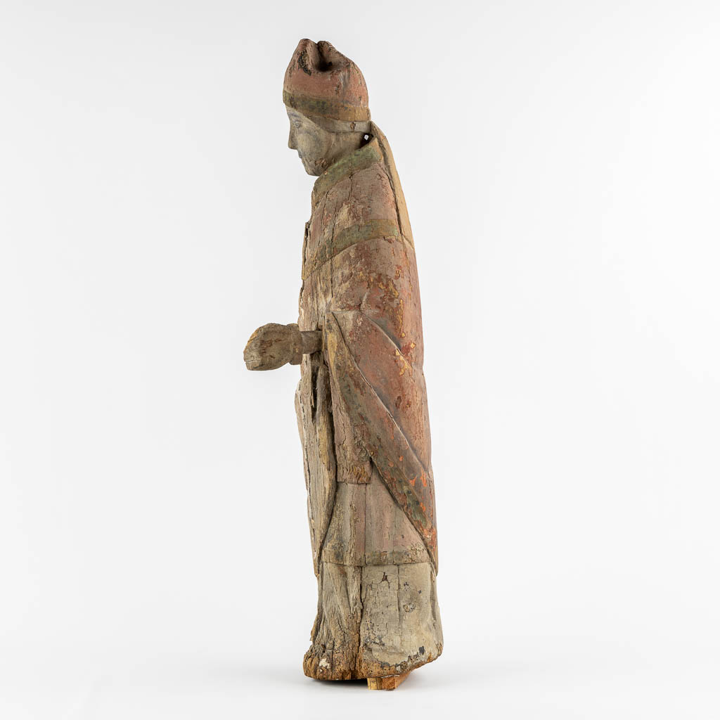 An antique wood-sculptured figurine of a Bishop, Roman, mid-13th/early 14th C. (L:23 x W:27 x H:88 cm)