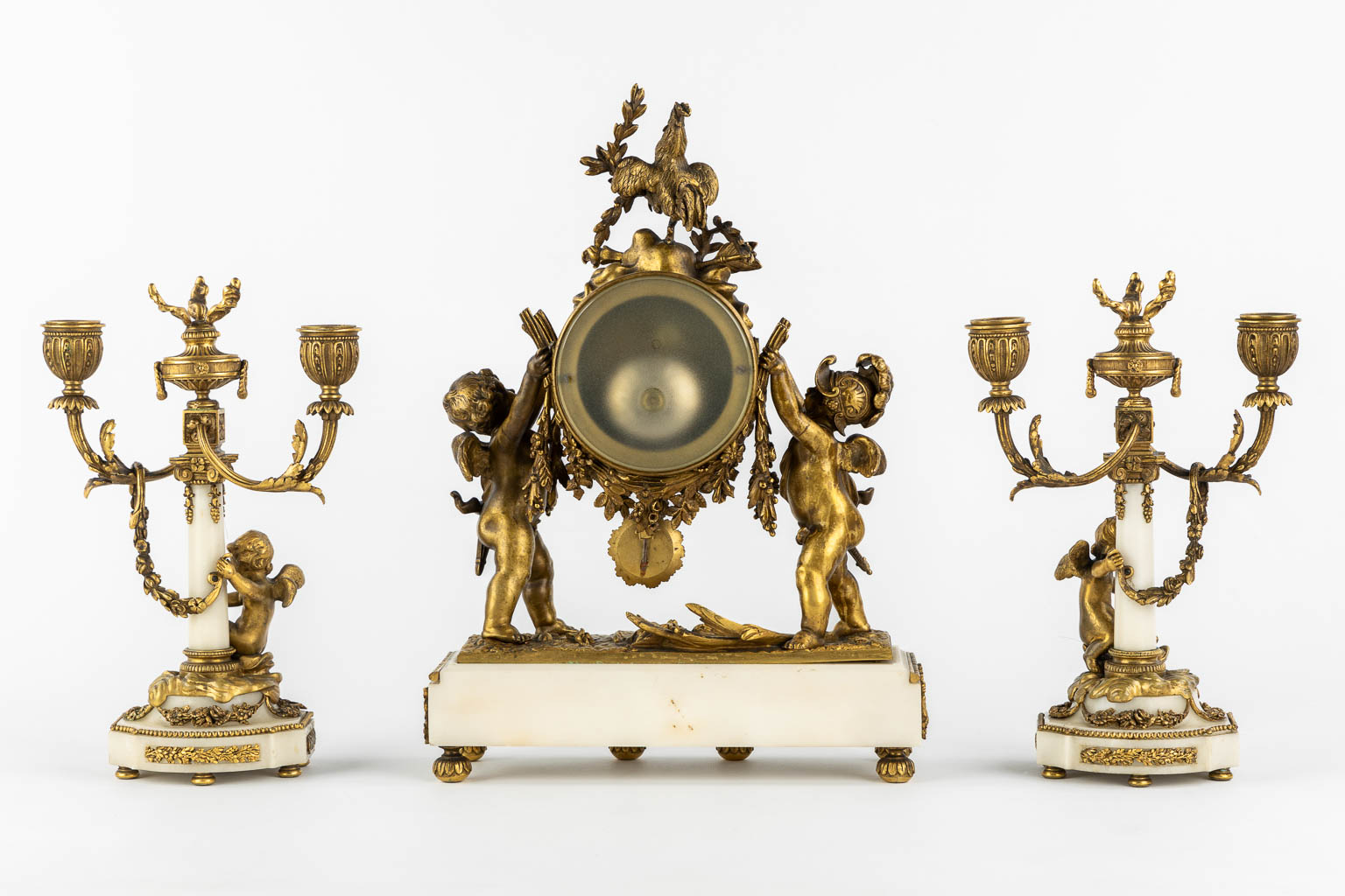 A three-piece mantle garniture clock and candelabra, bronze and marble, 19th C. (L:11 x W:27 x H:36 cm)