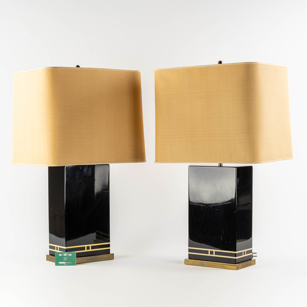 A pair of black-lacqured and brass inlay table lamps, in the style of Maison Jansen. (L:16 x W:24 x H:83 cm)