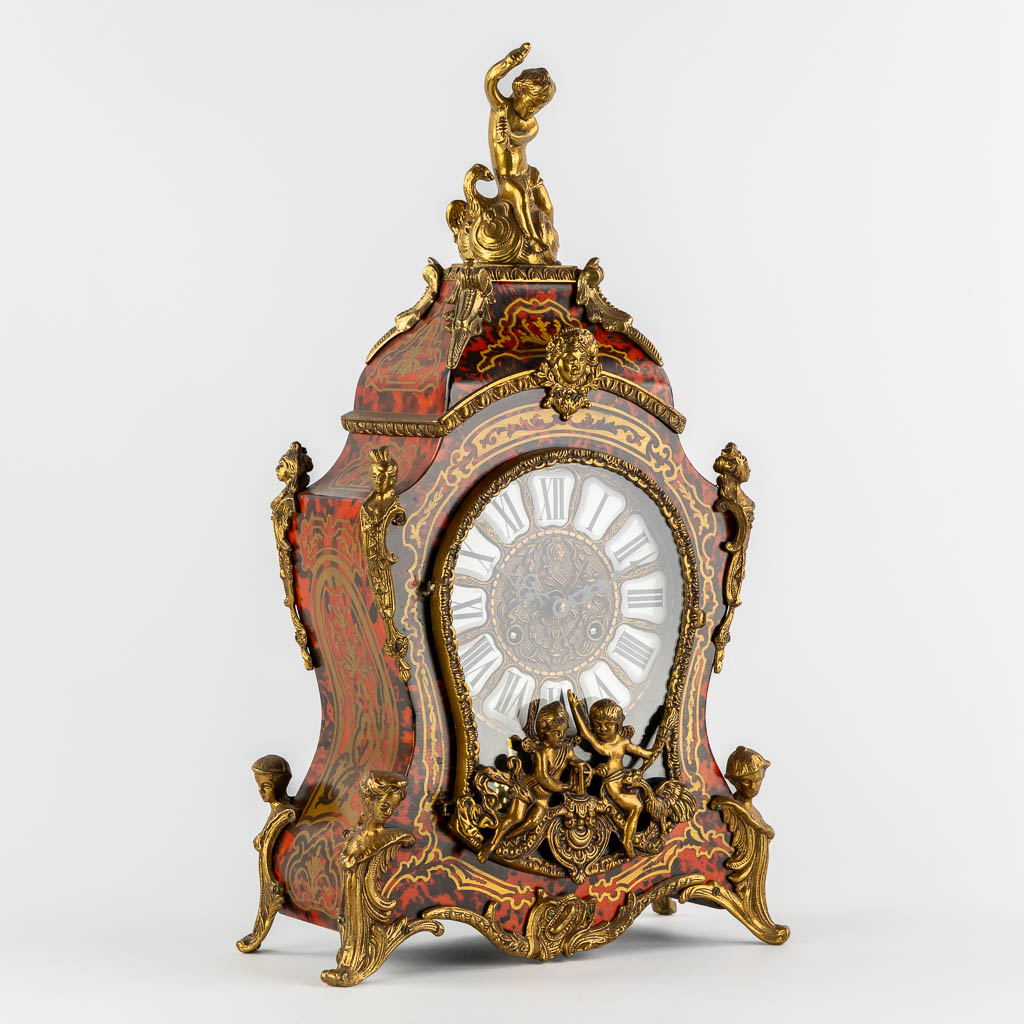 A mantle clock, boulle style marquetry inlay, mounted with gilt bronze. 20th C. (L:15 x W:32 x H:56 cm)