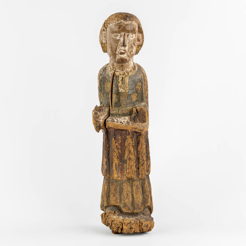 An antique wood sculpture of a Deacon, Roman period, possibly Catalonia. 12th C. (L:14 x W:15 x H:57 cm)