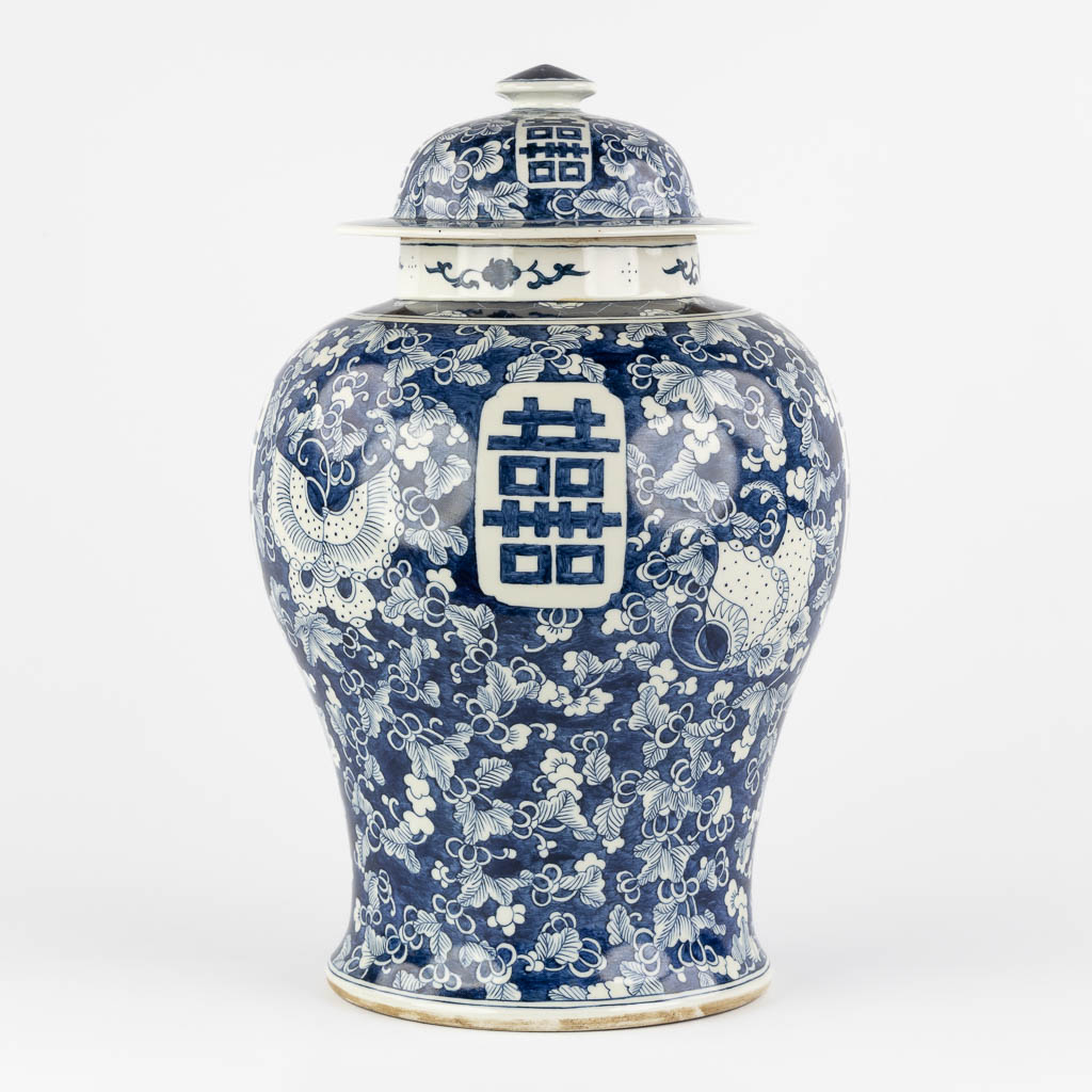 A Chinese baluster vase, blue-white with a Prunus decor and double XI sign. 19th/20th C. (H:42 x D:26 cm)