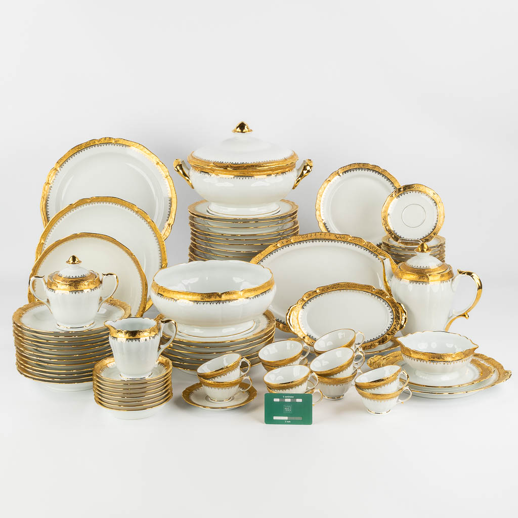 ULIM Limoges, a large dinner and coffee service, porcelain with a gilt rim. (L:26 x W:31 x H:20 cm)