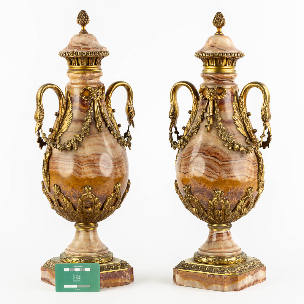 A pair of marble and bronze cassolettes in Empire style, decorated with swans. Circa 1880. (L:17 x W:21 x H:53 cm)