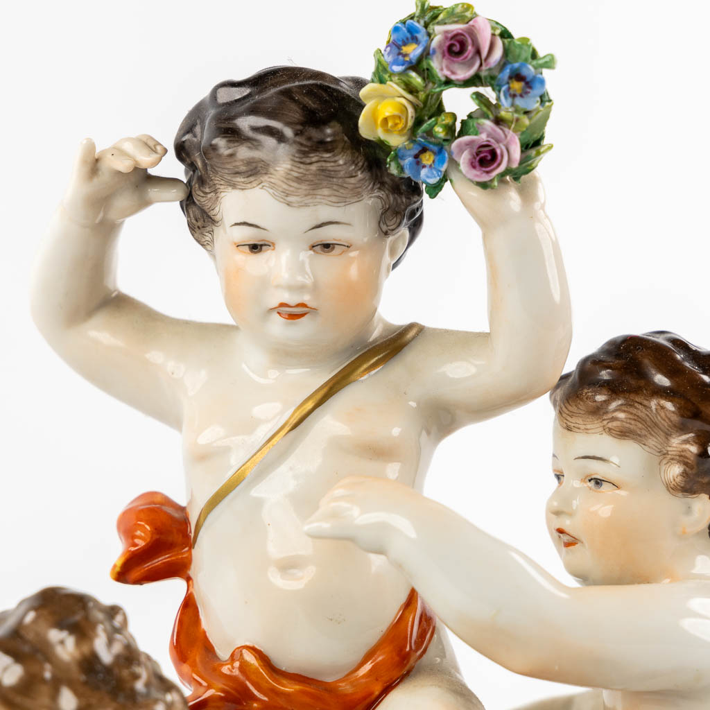 Volkstedt, Rudolstadt, a polychrome porcelain group with putti. (L:12,5 x W:23,5 x H:24 cm)