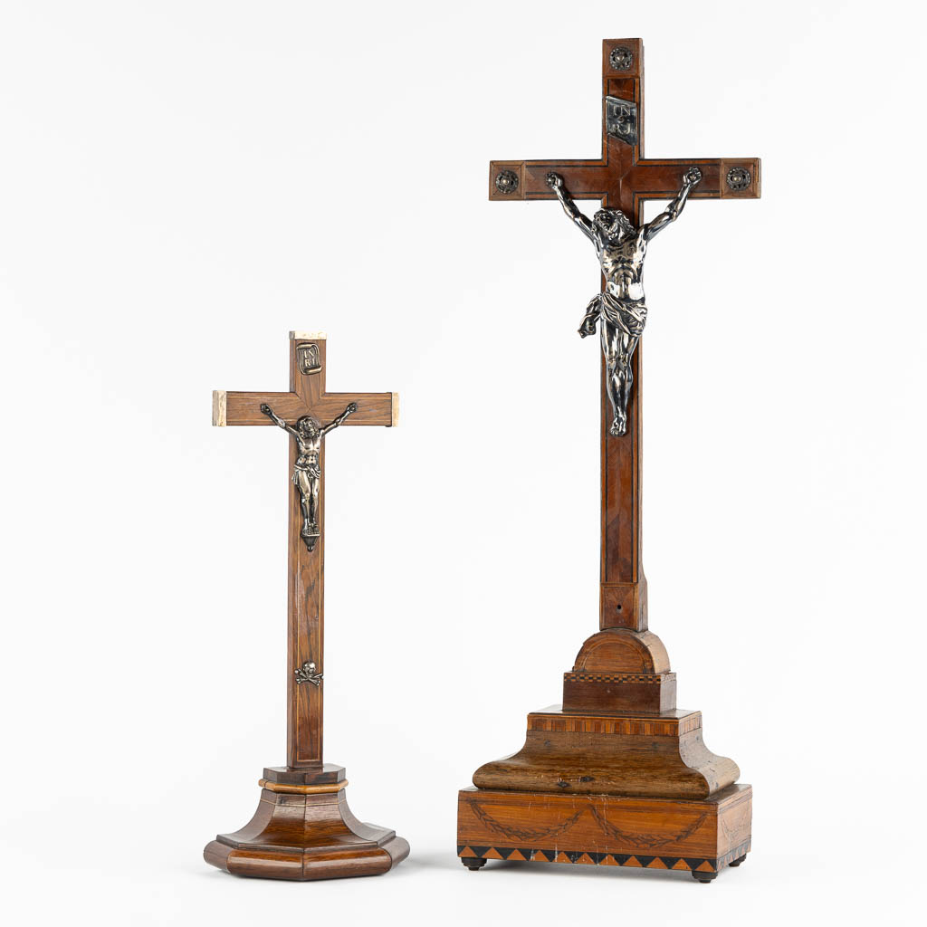 Two crucifixes with a silver Corpus Christi, 19th C. (W:24 x H:70 cm)