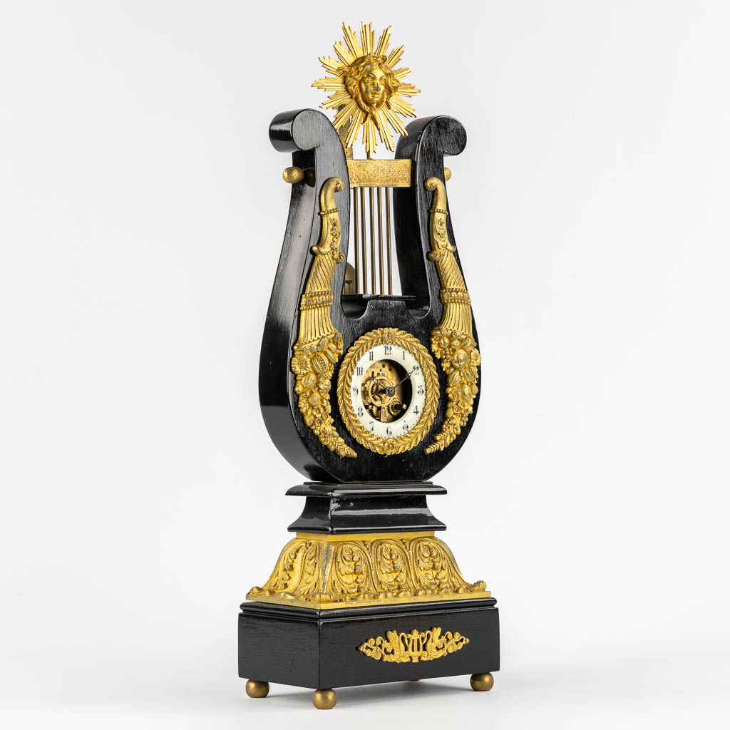 A Lyre mantle clock, gilt bronze and marble. 19th C. (L:13 x W:22 x H:61 cm)