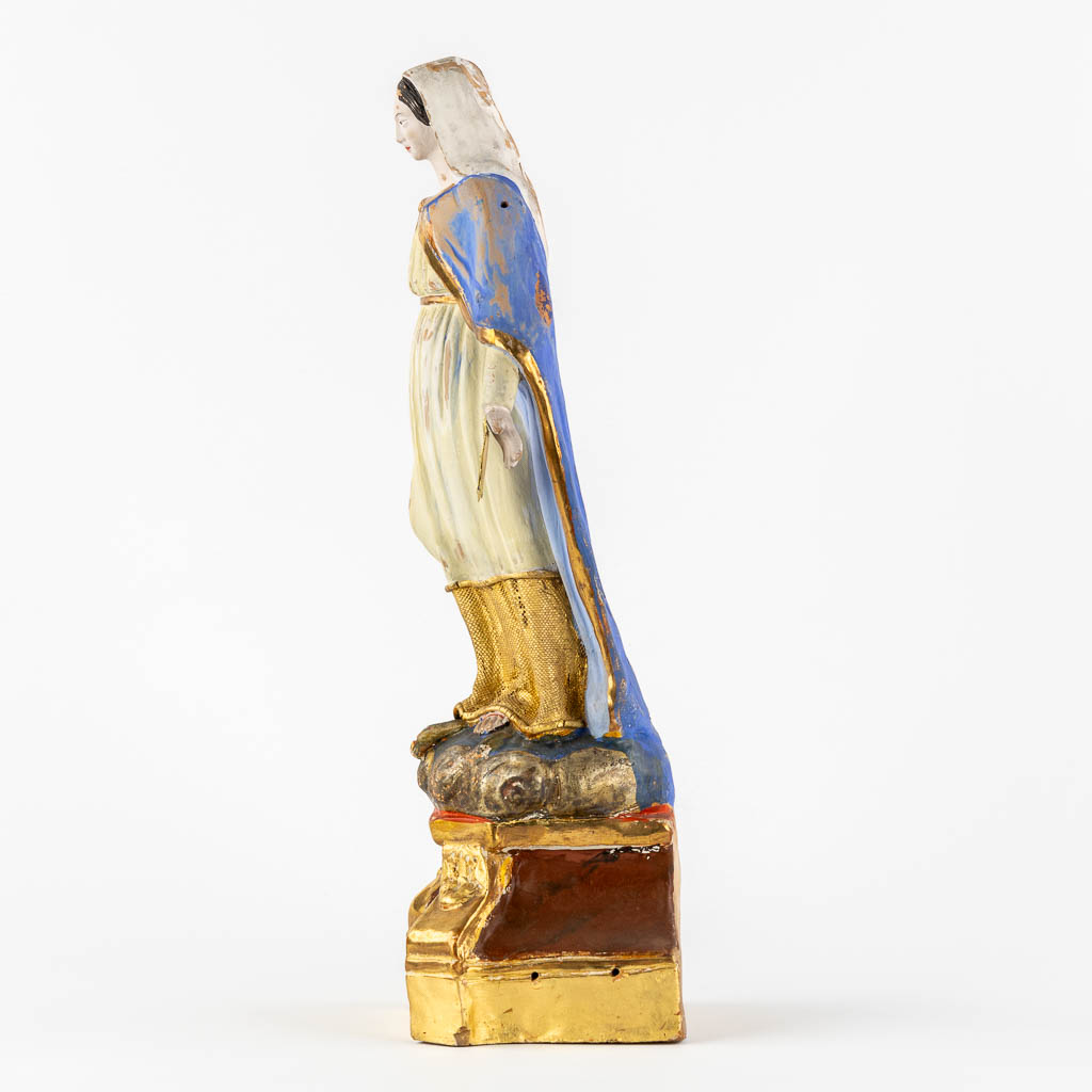 A patinated terracotta figurine of The Virgin Mary. (c1900)