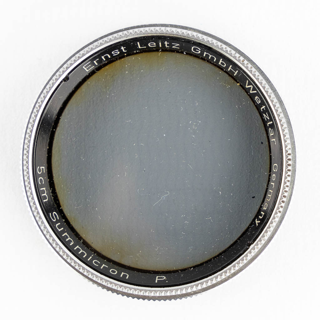 Leica, Four lenses and two filters. (H:15,5 cm)