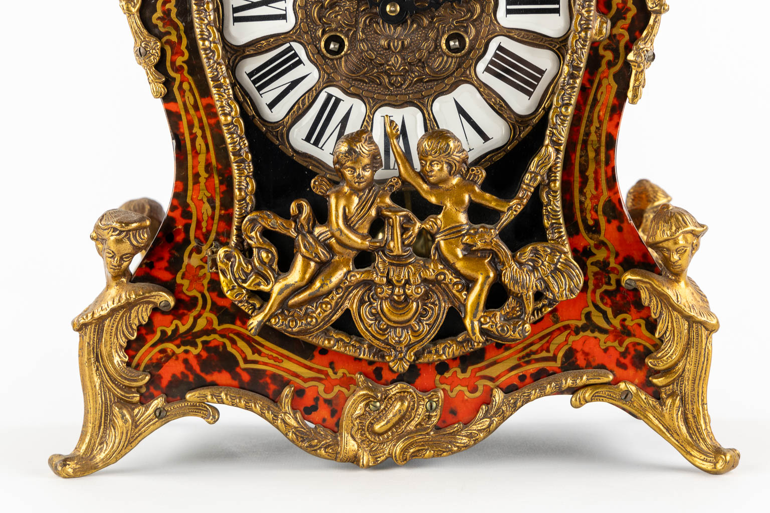 A mantle clock, boulle style marquetry inlay, mounted with gilt bronze. 20th C. (L:15 x W:32 x H:56 cm)