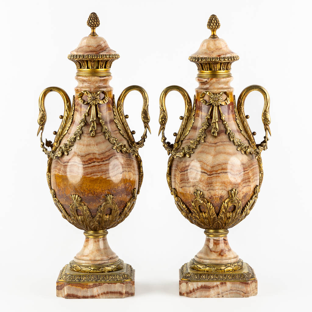 A pair of marble and bronze cassolettes in Empire style, decorated with swans. Circa 1880. (L:17 x W:21 x H:53 cm)