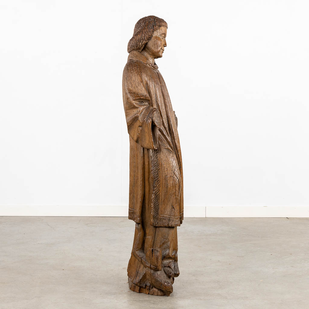 An antique, wood-sculptured figurine of Dacon Laurentius, Gothic, circa 1400. (L:22 x W:36 x H:117 cm)