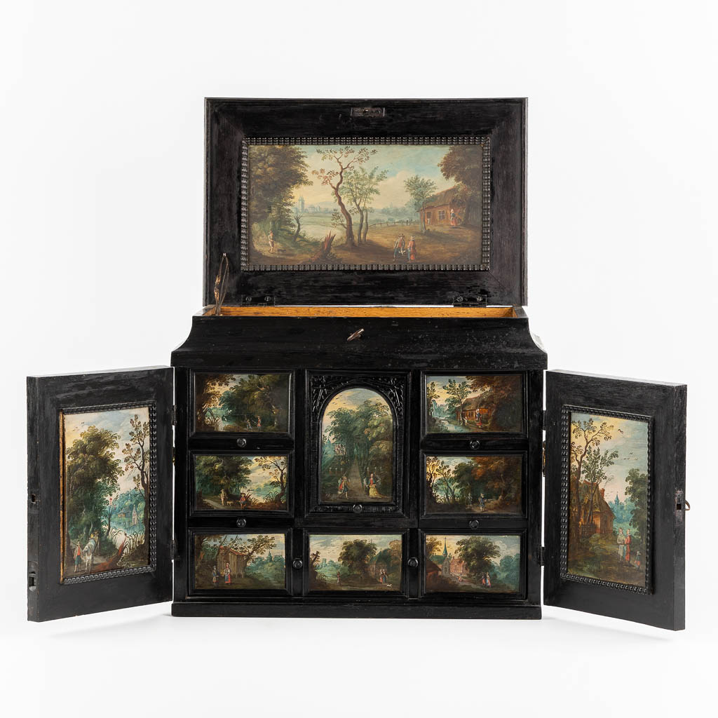 An antique 'Antwerp Art Cabinet', 11 miniature paintings, ebonised wood. (L:26,5 x W:43 x H:35 cm)