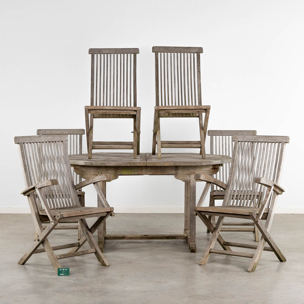 A garden table, four chairs and two armchairs, teak. (L:110 x W:150 x H:76 cm)