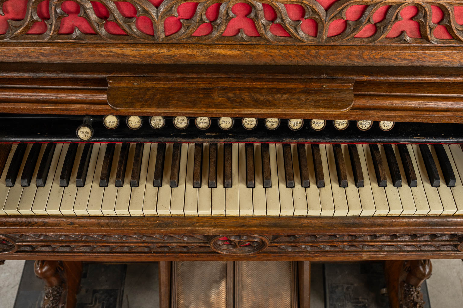 An antique organ, sculptured wood in Gothic Revival style. Circa 1900.