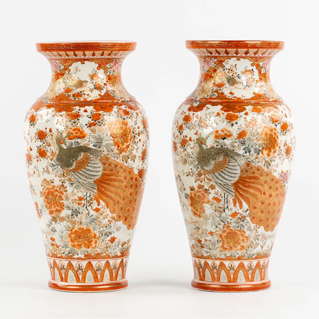 A pair of Japanese Kutani vases, richly finished with a peacock decor. (H:37 x D:19 cm)