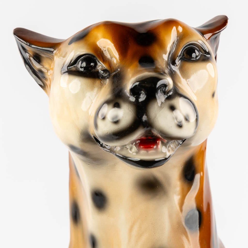 A decorative figurine of a leopard, patinated resine. 