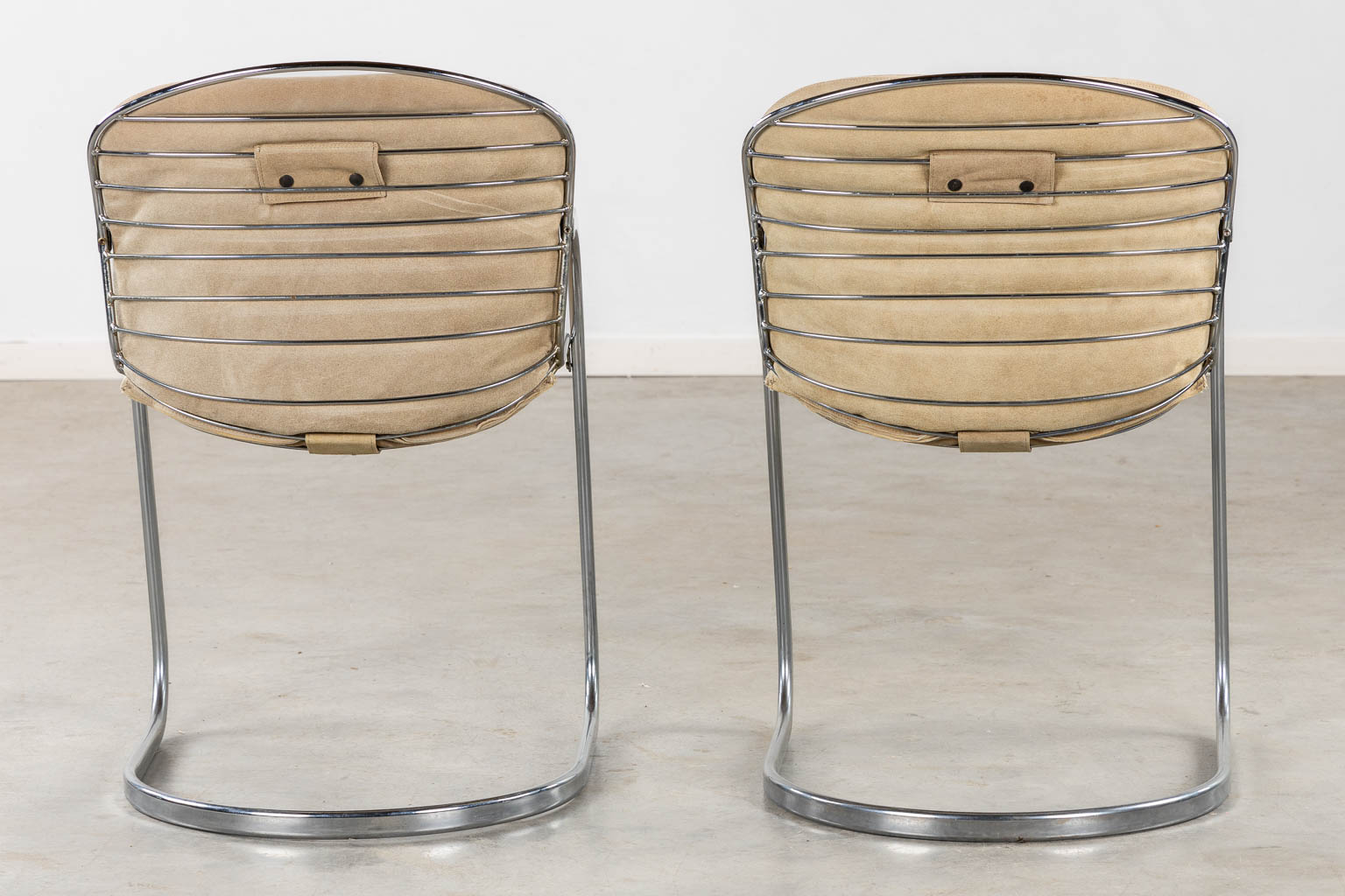 A pair of cantilever chairs, chromed metal. in the style of Gastone Rinaldi. (L:60 x W:52 x H:82 cm)